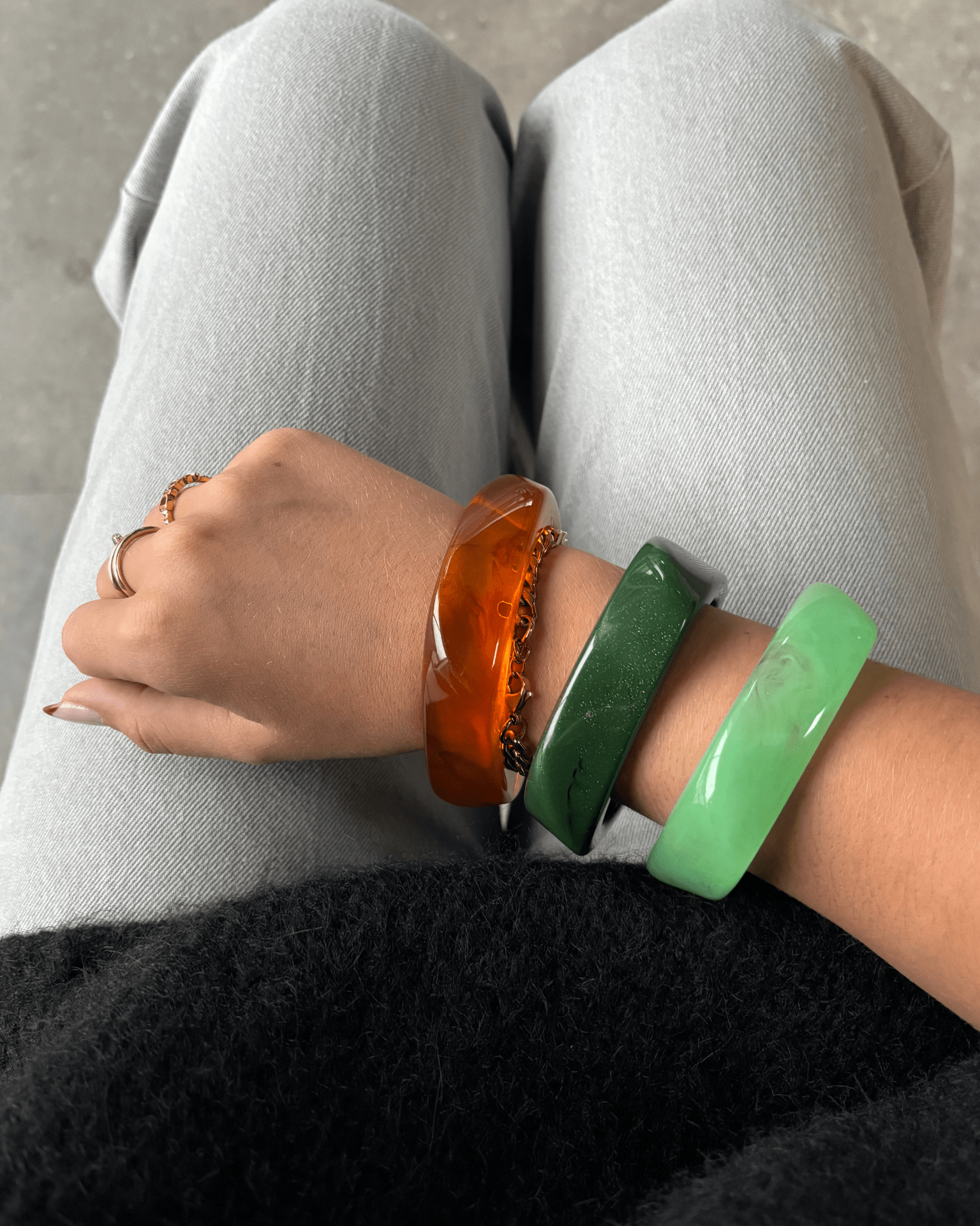 Tre chunky Forest Mix armbånd i ravfarvet, mørkegrøn og lysegrøn akryl på et håndled